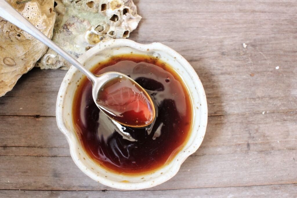 oyster sauce in bowl with spoon-leancleanandbrie.com